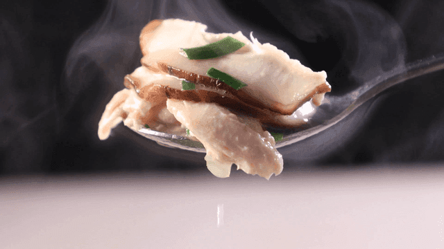 Spoonful of steaming chicken soup