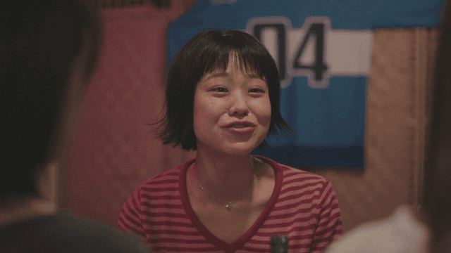 줄무늬 셔츠를 입은 실내에서 대화하는 여성