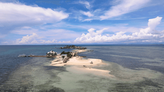 Small island in clear blue sea
