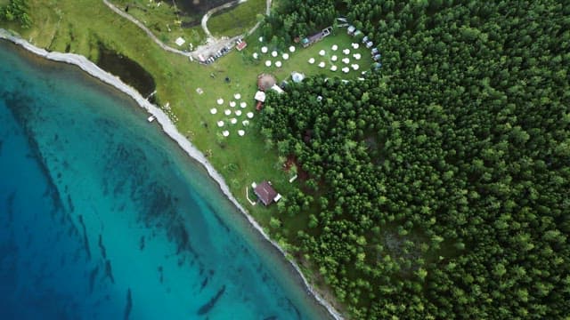 Serene lakeside forest with yurts