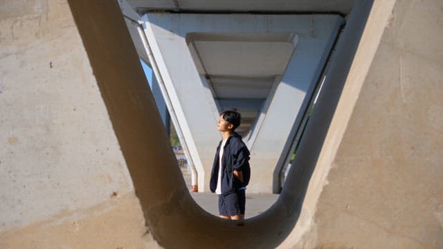 Man stretching under a bridge