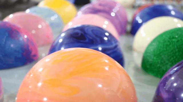 Colorful hemispherical chocolates displayed on a table