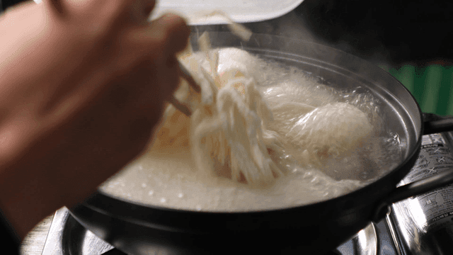 Kalguksu spread out in boiling water