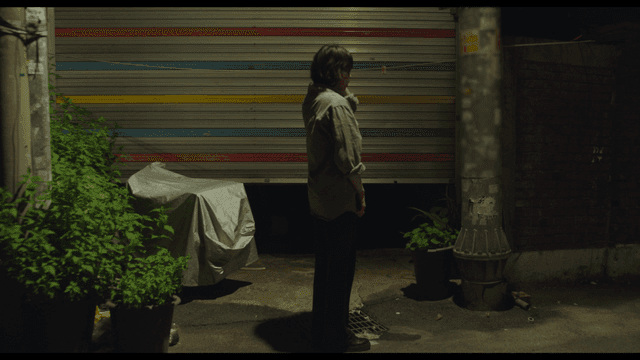 어두운 골목에 서서 자책하고 있는 여성