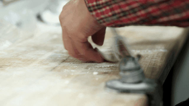 Hands preparing dough on a floured surface
