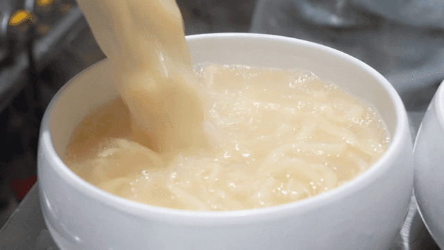 Chicken kalguksu with broth poured over it
