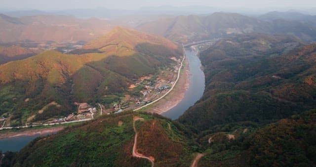 Serene River Winding Through Autumn Hills