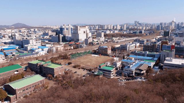 City skyline with forested hills