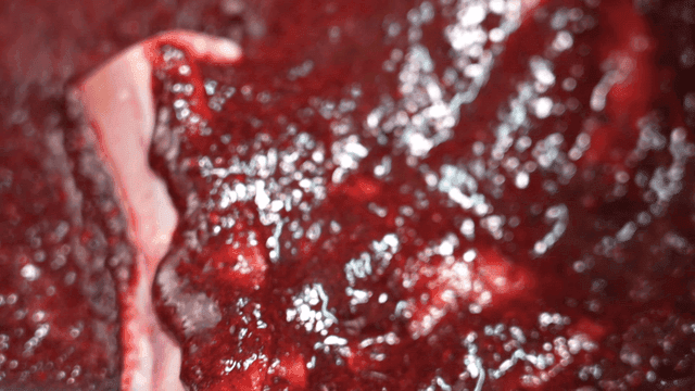 Raw meat coated in purple sauce