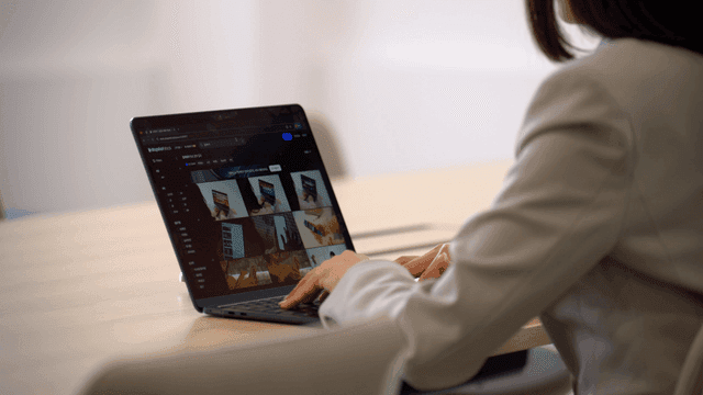 Female office worker working on laptop in office