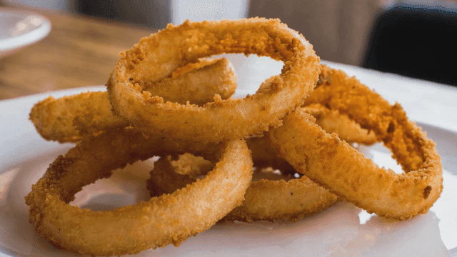 Crispy onion rings on a white plate
