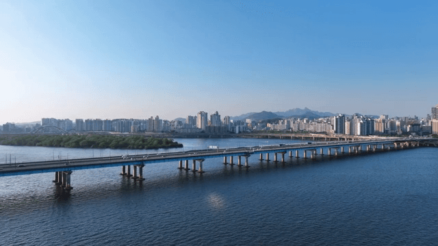 Bridge over a river with city skyline