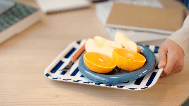 Tray with sliced fruits on a table