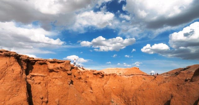 Clouds in the blue sky above the desert cliffs