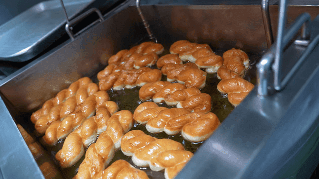 Twisted donuts fried in hot oil