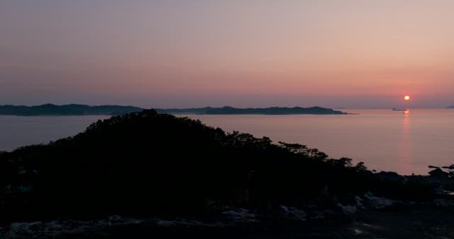 Serene Purple Sunset over Calm Seaside