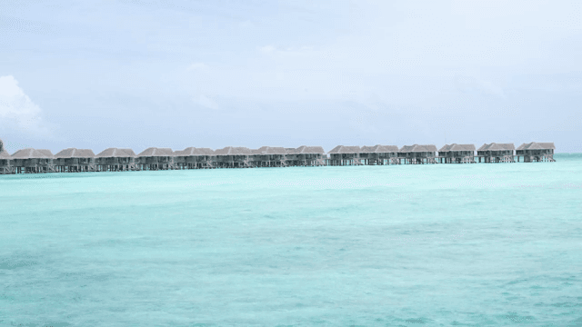 Overwater bungalows on a clear ocean