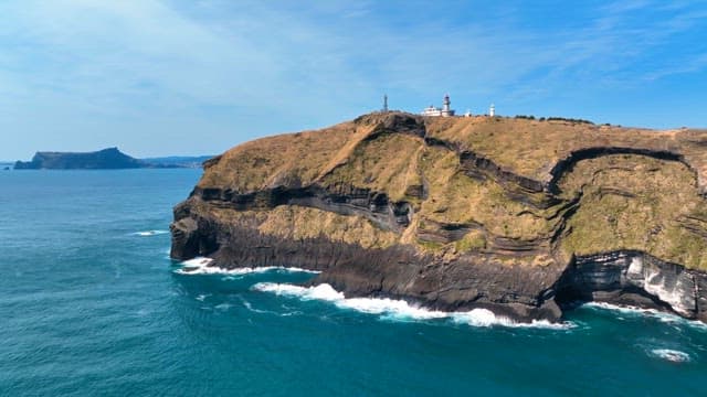 Scenic coastal cliff with a lighthouse