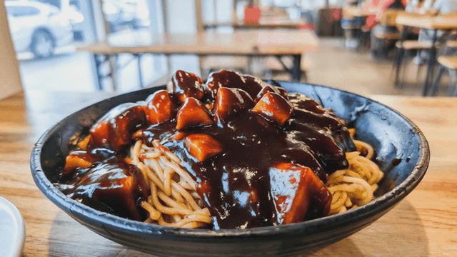 Bowl of jajangmyeon on wooden table