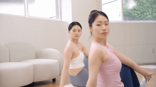 Two women practicing yoga indoors