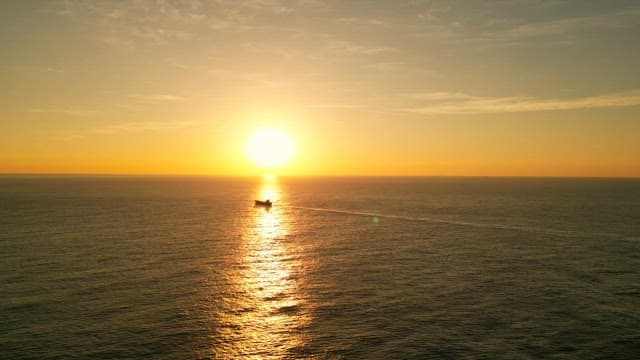 Sunset over the calm ocean horizon