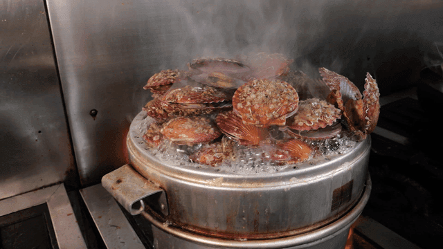 Steamed red snapper in pot on stove