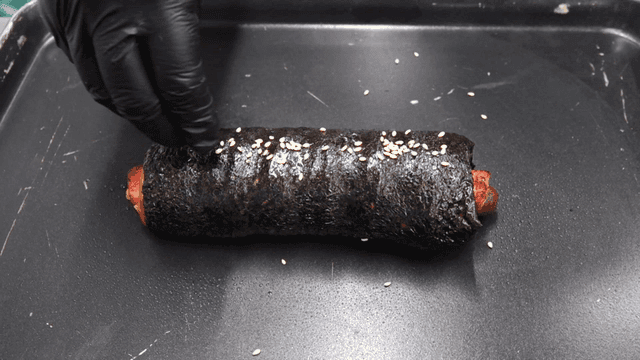 Bread shaped like gimbap sprinkled with sesame seeds