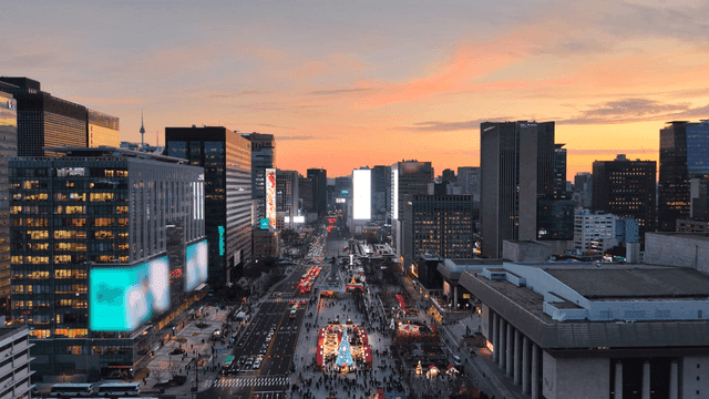 Cityscape with festive lights at sunset