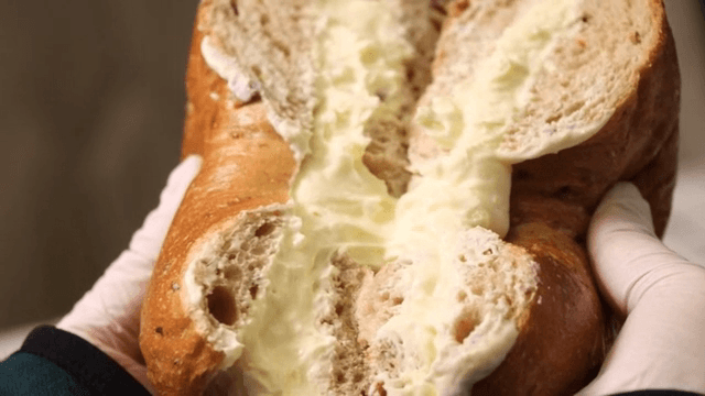 Cross section of a bagel filled with cream cheese