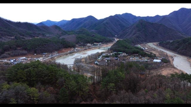 Village surrounded by rivers and lush green mountains