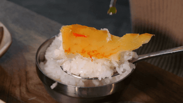 Spoonful of rice and piece of steamed rockfish