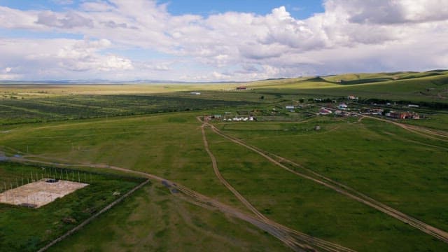 Wide Field under a Picturesque Cloud and Blue Sky