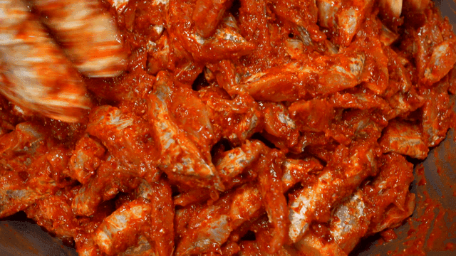 Fish being mixed with seasoning