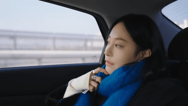 Profile of a woman looking out the taxi window at the road