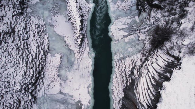 Snow-covered canyon with a frozen river