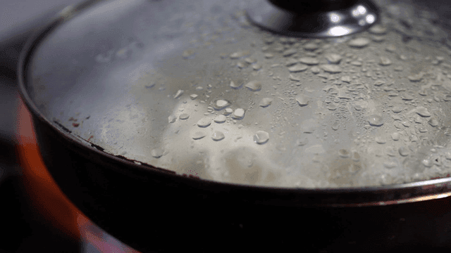 Pot with steam condensation on lid on stove