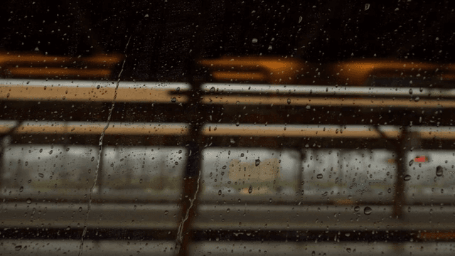 Raindrops falling on a train window