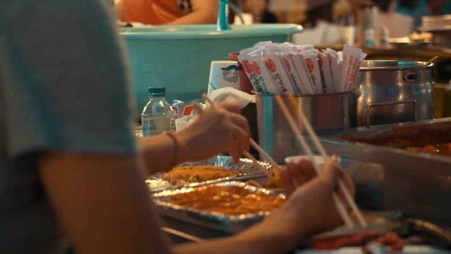 Close-up of a bustling street food stall