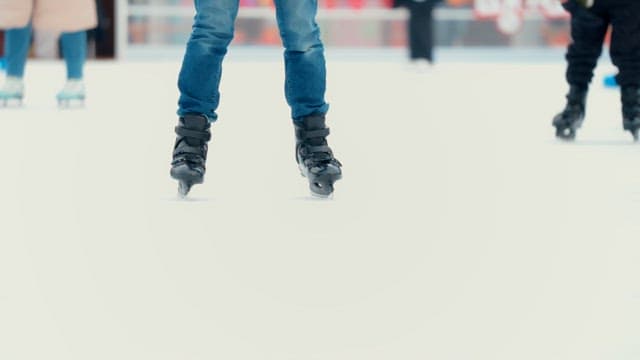 People ice skating at a rink