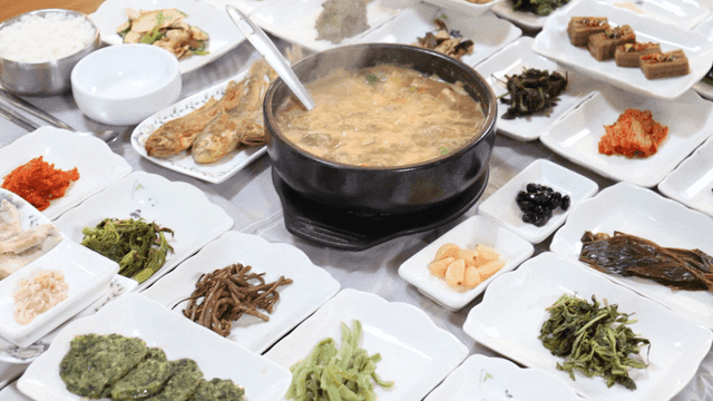 Table with variety of Korean side dishes