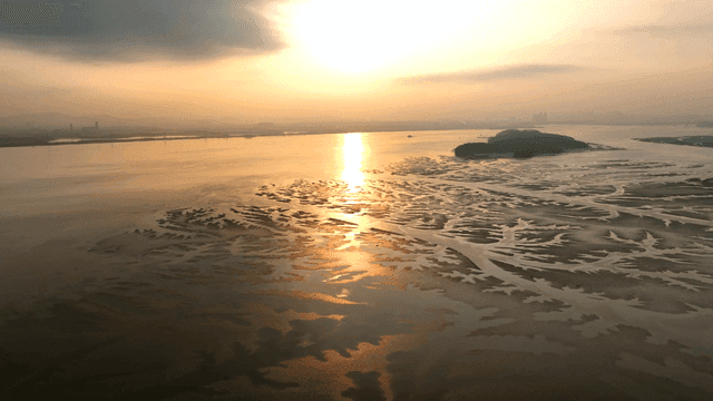 Sunset over a serene tidal flat