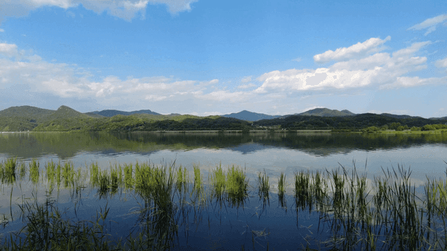 Tranquil lake with mountains visible in distance