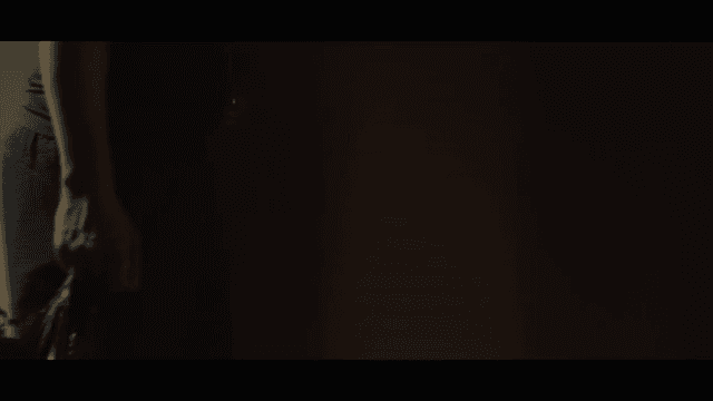 Person walking in a dimly lit hallway
