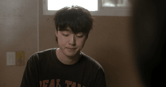 Young man laughing then becoming awkwardly serious