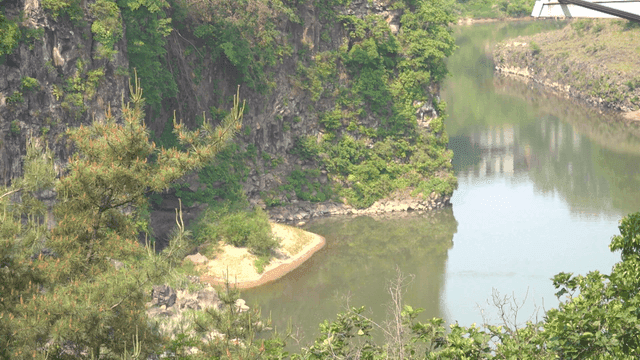 Tranquil river surrounded by blue cliffs