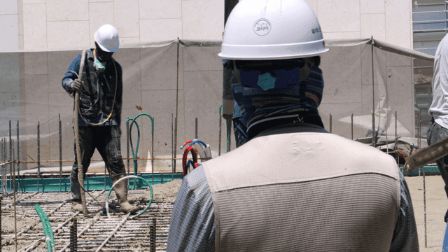 Construction workers pouring concrete