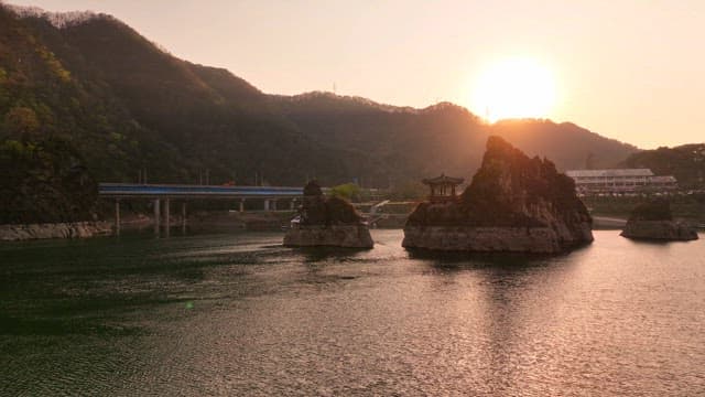 Sunset over a river with rocky islets