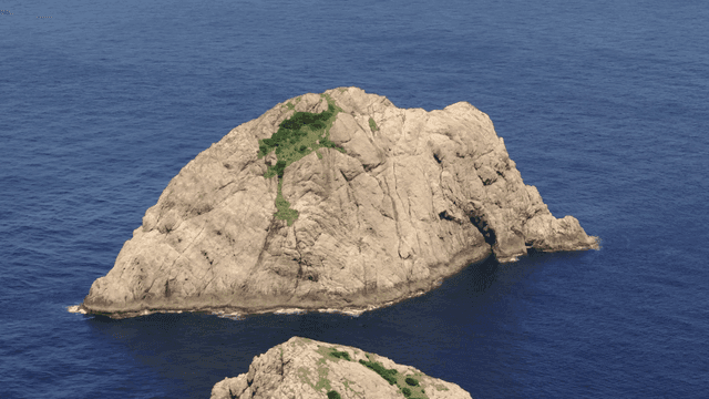 A rocky island surrounded by blue sea