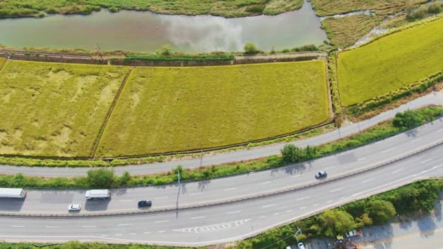 View of lush green fields and a river