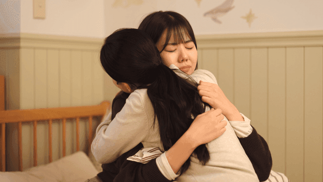 Mother and daughter sharing comforting hug